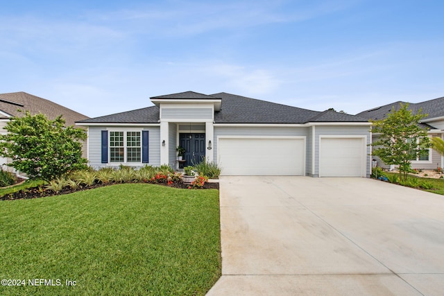 view of front facade featuring a garage and a front lawn