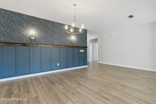 interior space with hardwood / wood-style floors and a notable chandelier