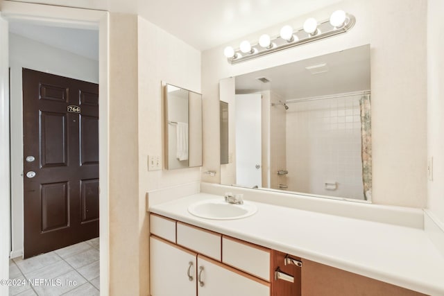 bathroom featuring tile patterned flooring, vanity, and a shower with shower curtain