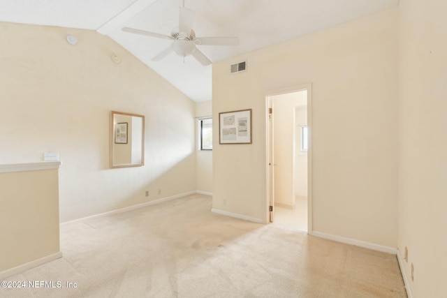 empty room with light carpet, ceiling fan, and lofted ceiling with beams