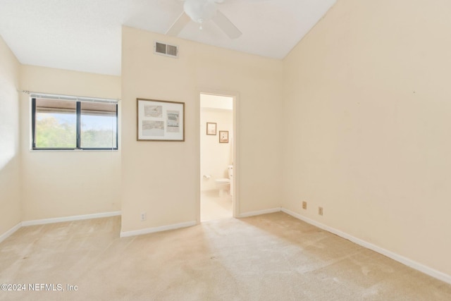 spare room featuring ceiling fan and light carpet