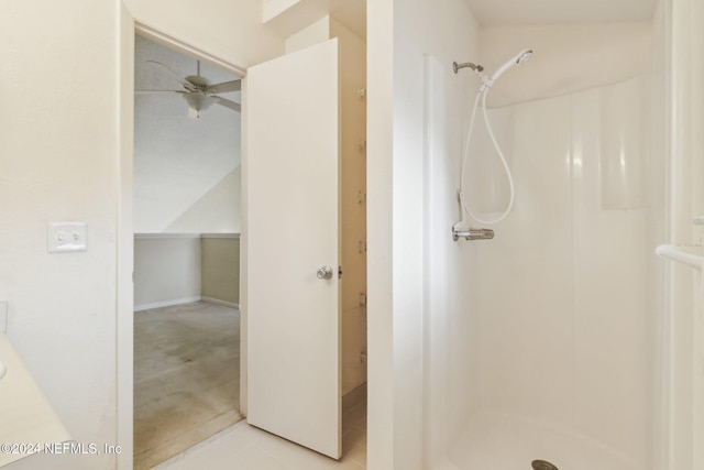 bathroom with walk in shower and ceiling fan