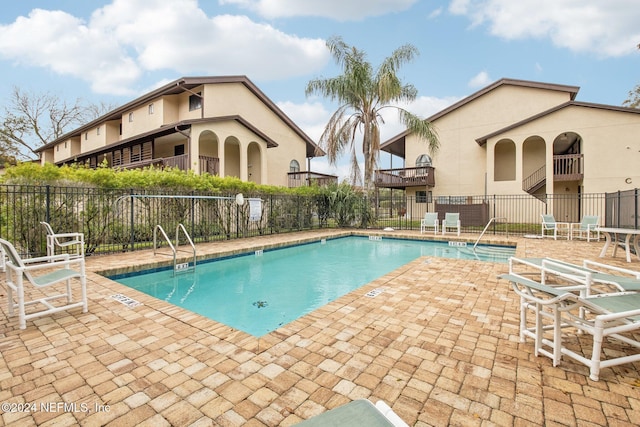 view of swimming pool with a patio area