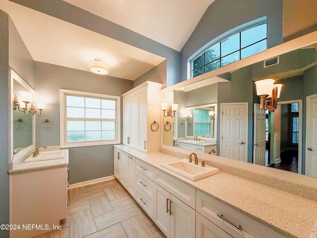 bathroom featuring vanity and lofted ceiling