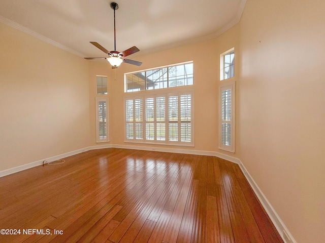 unfurnished room featuring ceiling fan, hardwood / wood-style floors, and crown molding