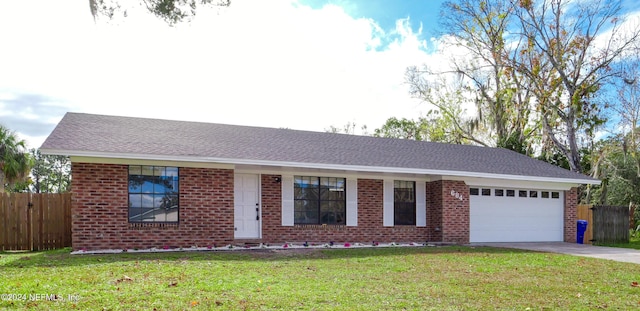 ranch-style home featuring a garage and a front lawn