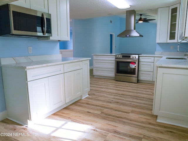 kitchen with white cabinets, sink, stainless steel appliances, and extractor fan