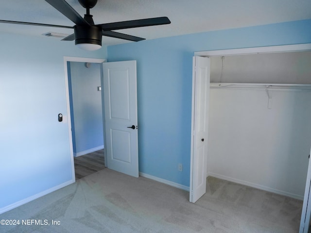 unfurnished bedroom with light carpet, a closet, and ceiling fan