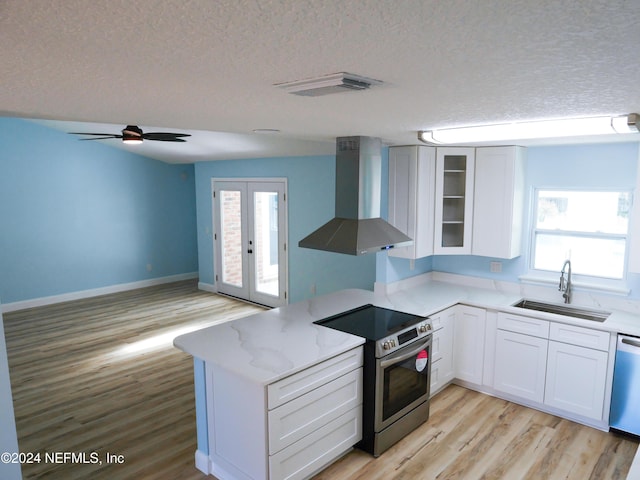 kitchen featuring white cabinets, sink, wall chimney exhaust hood, and appliances with stainless steel finishes