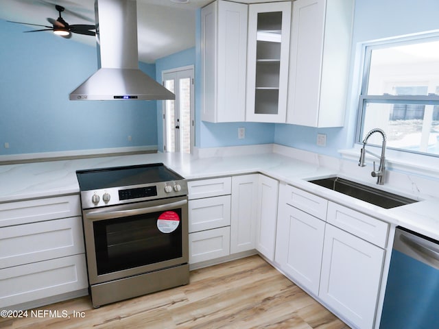 kitchen featuring white cabinetry, sink, stainless steel appliances, and ventilation hood