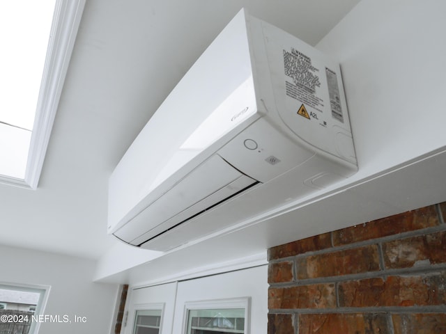 laundry area featuring a wall unit AC