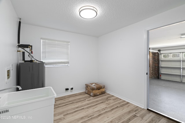 bedroom featuring light hardwood / wood-style flooring and a textured ceiling