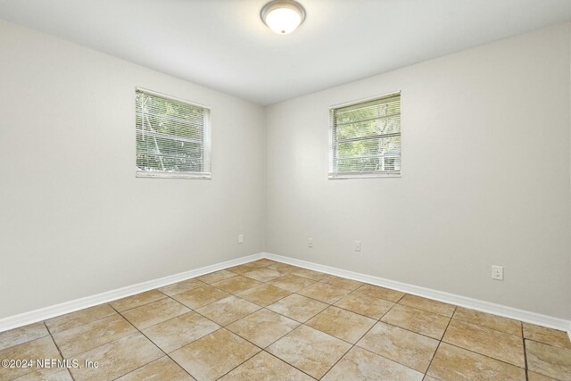 spare room featuring light tile patterned floors