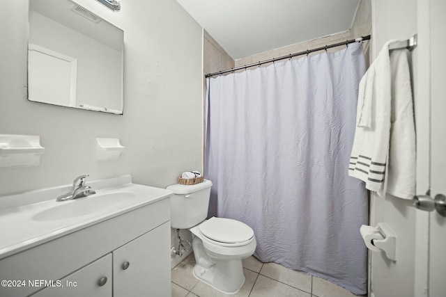 bathroom featuring toilet, vanity, tile patterned floors, and a shower with shower curtain