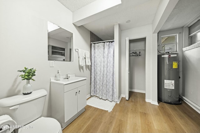 bathroom with electric water heater, hardwood / wood-style floors, a textured ceiling, toilet, and vanity