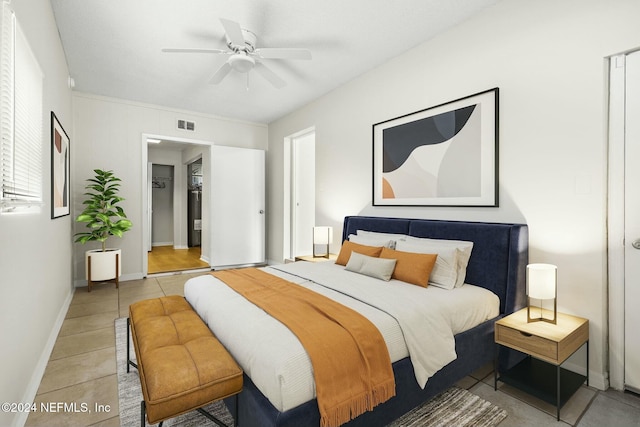 tiled bedroom featuring ceiling fan