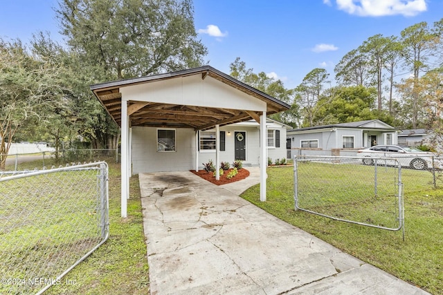 bungalow-style home with a front lawn and a carport