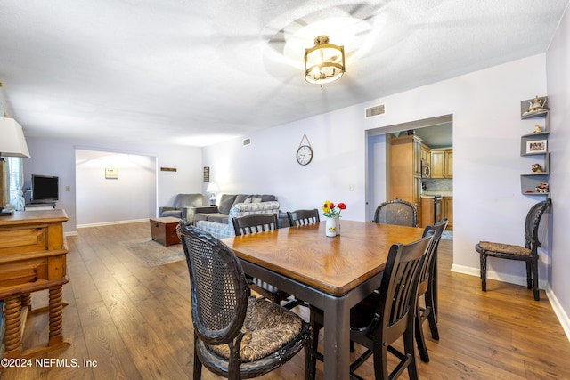 dining area with wood-type flooring