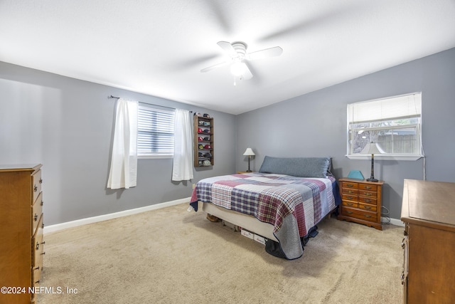 bedroom featuring ceiling fan and light colored carpet