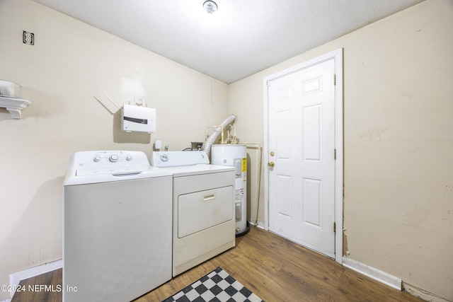 laundry room with dark hardwood / wood-style flooring, washing machine and dryer, and electric water heater