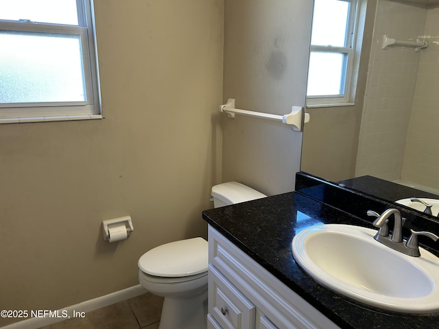 bathroom featuring toilet, vanity, baseboards, and tile patterned floors