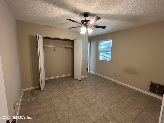 unfurnished bedroom featuring light tile patterned floors, baseboards, visible vents, and a closet