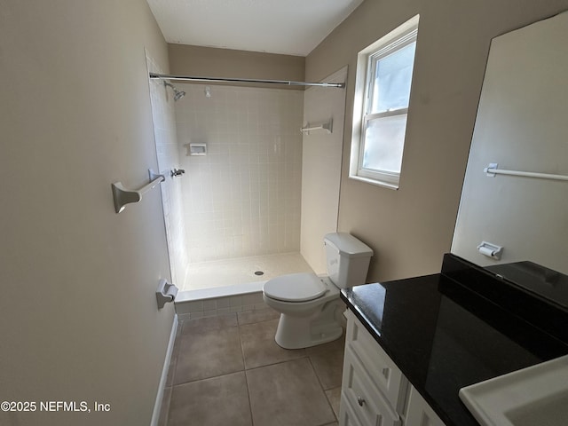 bathroom featuring a stall shower, vanity, toilet, and tile patterned floors