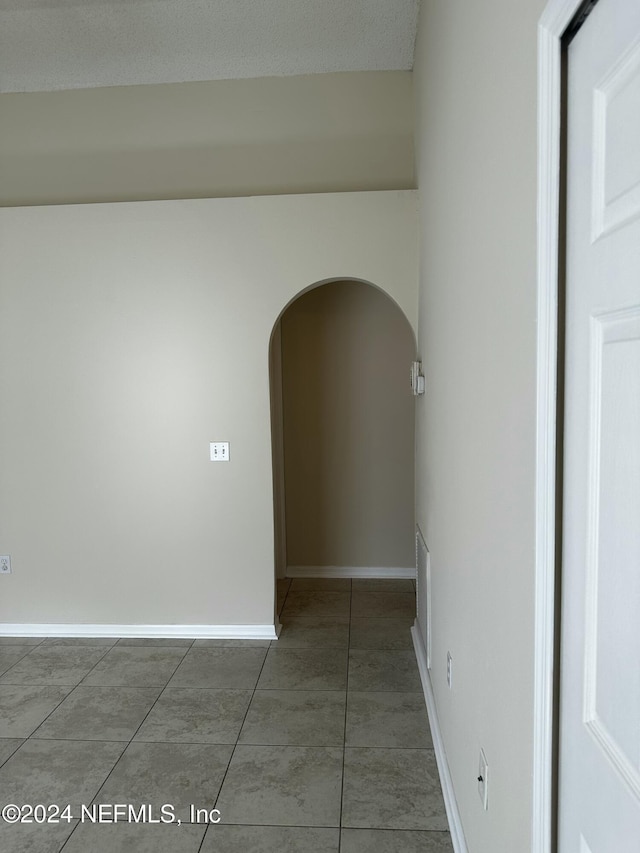 hall featuring tile patterned flooring