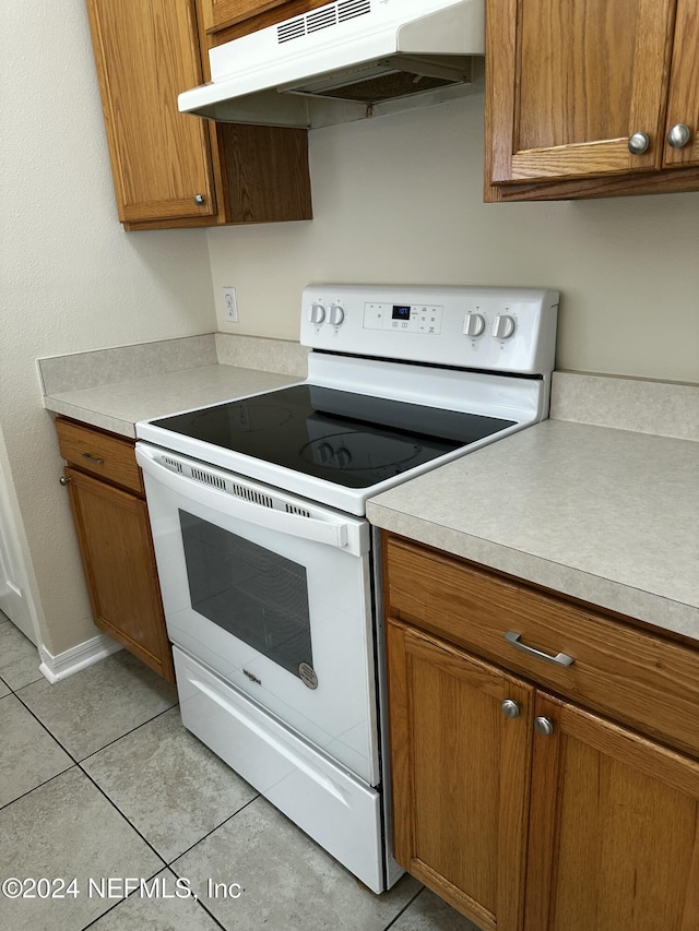 kitchen featuring white range with electric stovetop and light tile patterned floors