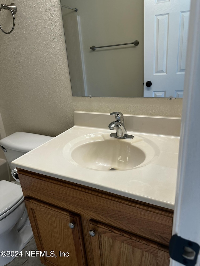 bathroom featuring vanity and toilet