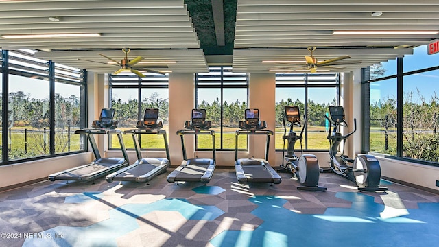 gym with ceiling fan and a wealth of natural light