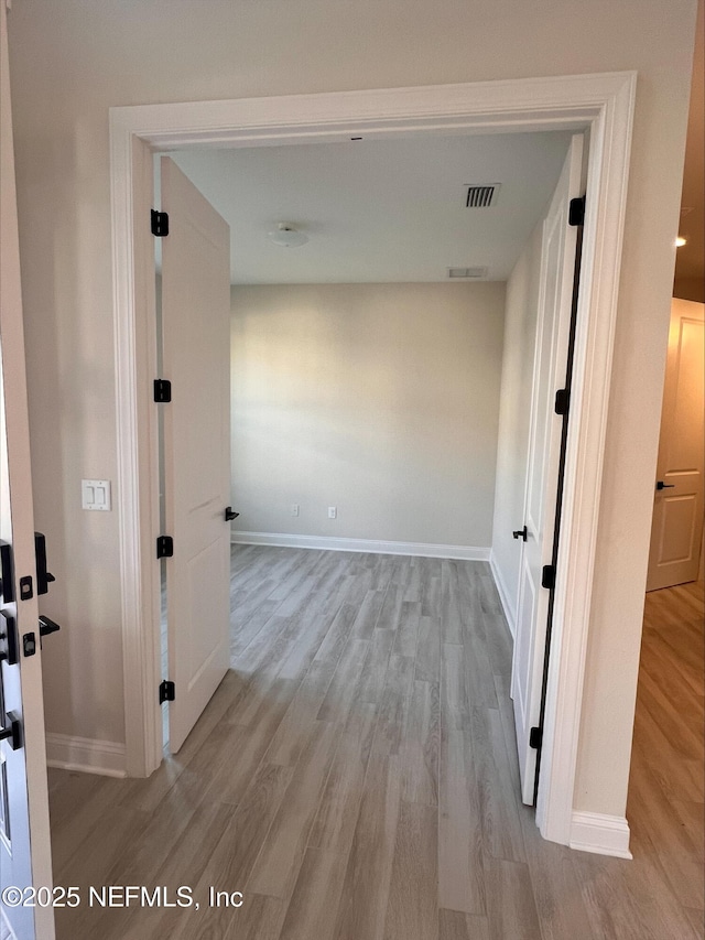 hallway with light wood-type flooring