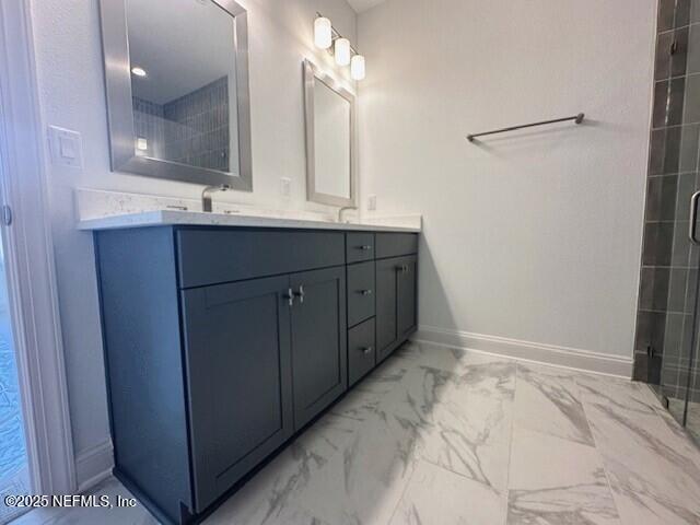 bathroom featuring vanity and a shower with shower door