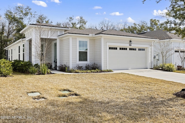 view of front of property with a garage and a front lawn