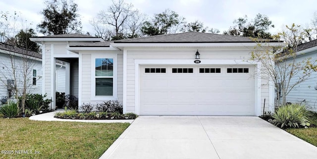 ranch-style house featuring a garage and a front yard