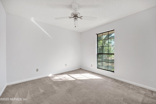 carpeted spare room with a textured ceiling and ceiling fan