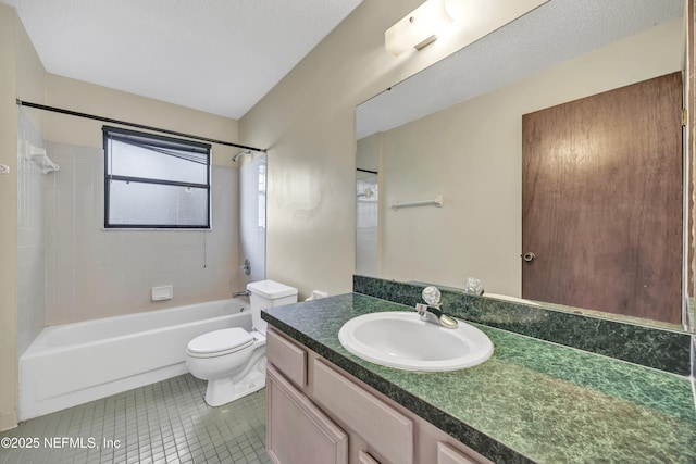 full bathroom with toilet, tiled shower / bath, vanity, tile patterned floors, and a textured ceiling