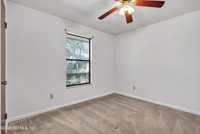 carpeted spare room with a textured ceiling and ceiling fan