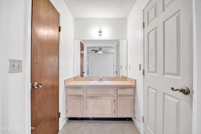 bathroom featuring ceiling fan, vanity, tile patterned floors, and a textured ceiling