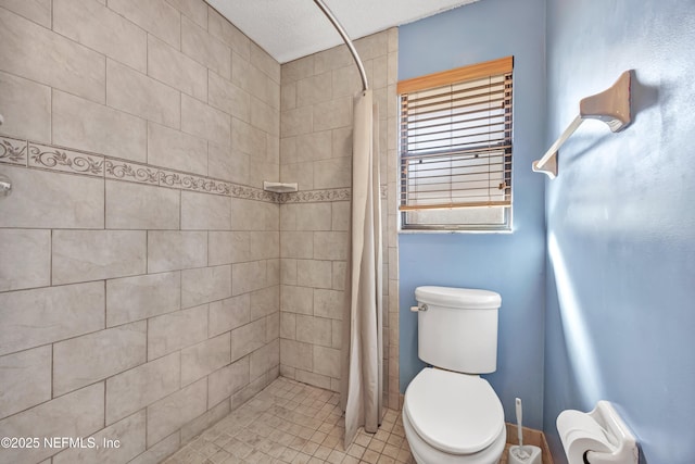 bathroom with curtained shower and toilet