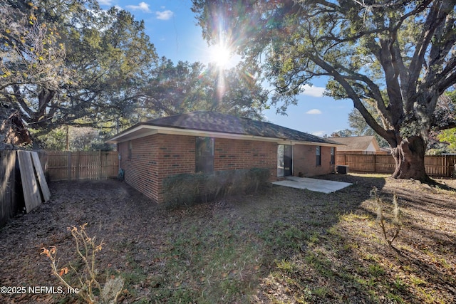 back of property featuring cooling unit and a patio