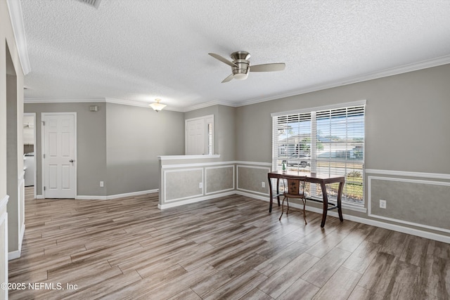 spare room with ceiling fan, a textured ceiling, hardwood / wood-style flooring, and crown molding