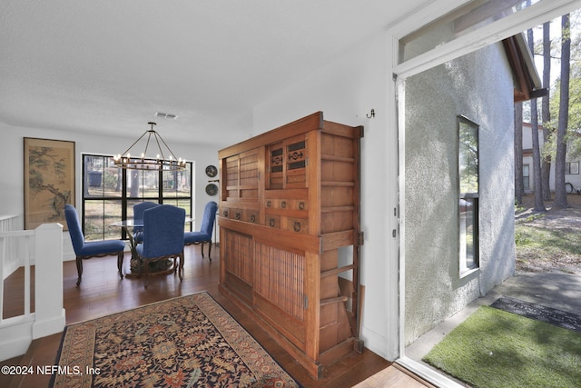 dining area featuring a chandelier and dark hardwood / wood-style flooring