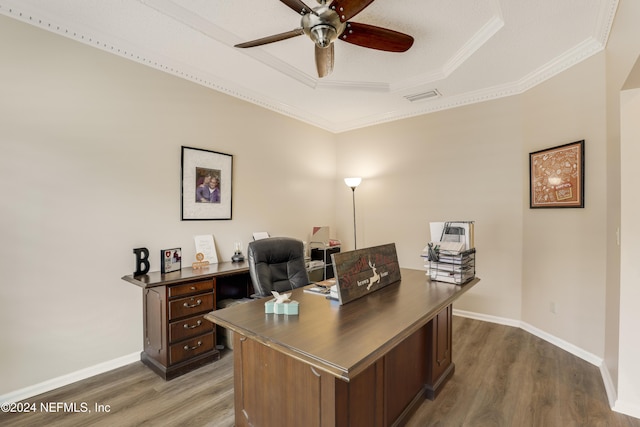 home office featuring ceiling fan, crown molding, dark hardwood / wood-style floors, and a tray ceiling