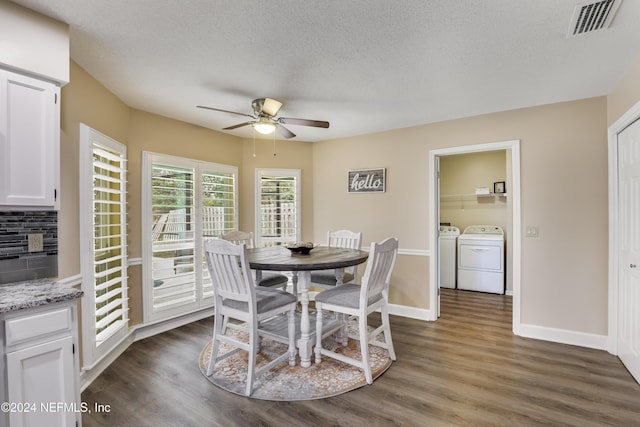 dining area featuring a textured ceiling, dark hardwood / wood-style floors, washing machine and clothes dryer, and ceiling fan