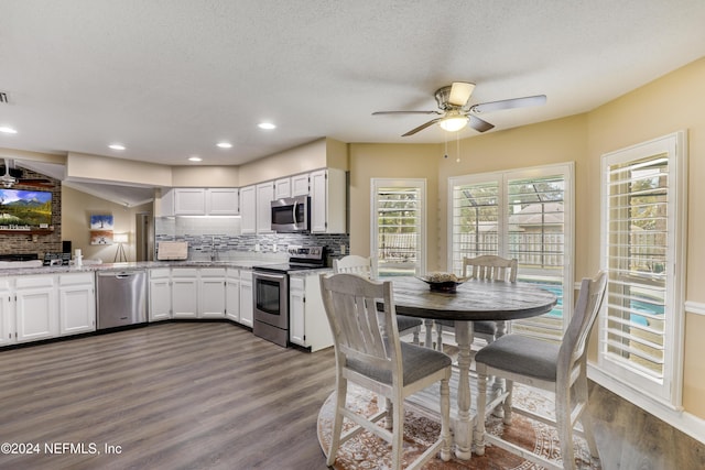 kitchen featuring white cabinets, backsplash, appliances with stainless steel finishes, and a textured ceiling