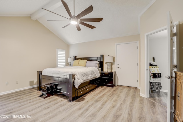 bedroom with ceiling fan, vaulted ceiling with beams, and light wood-type flooring