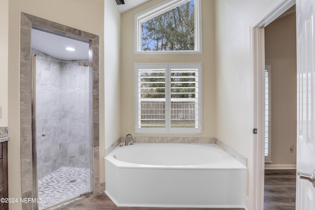 bathroom featuring separate shower and tub, vanity, and hardwood / wood-style floors