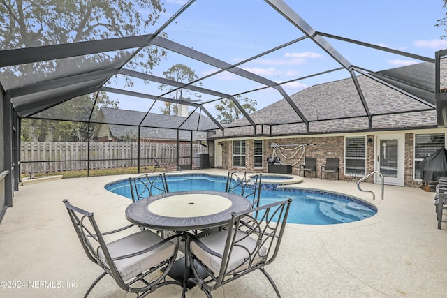 view of pool with a lanai, central AC, an in ground hot tub, and a patio