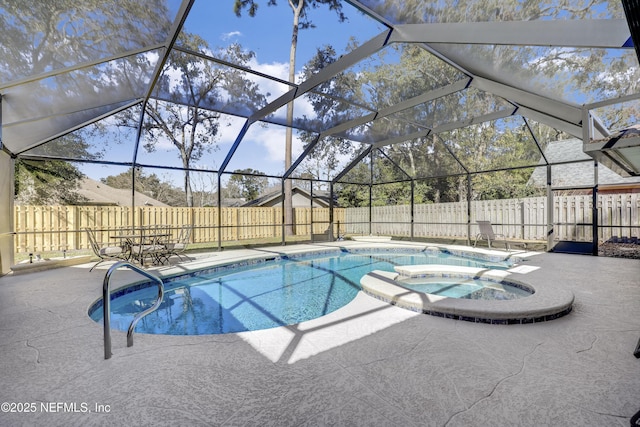 view of swimming pool featuring a lanai, a patio area, and an in ground hot tub